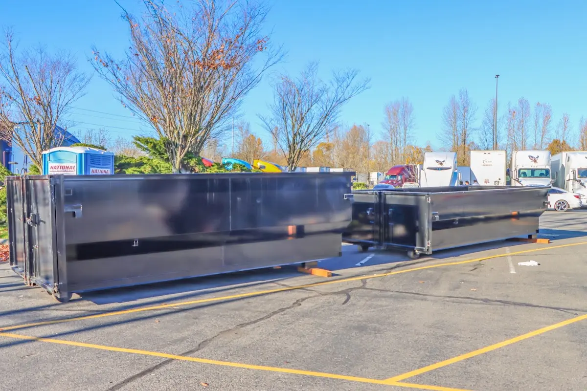 Professional dumpster rental service with roll-off container on residential driveway in Patterson